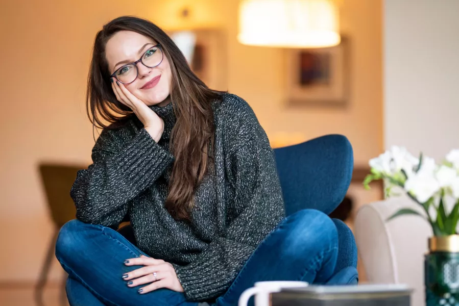 Woman sitting at home, looking relaxed