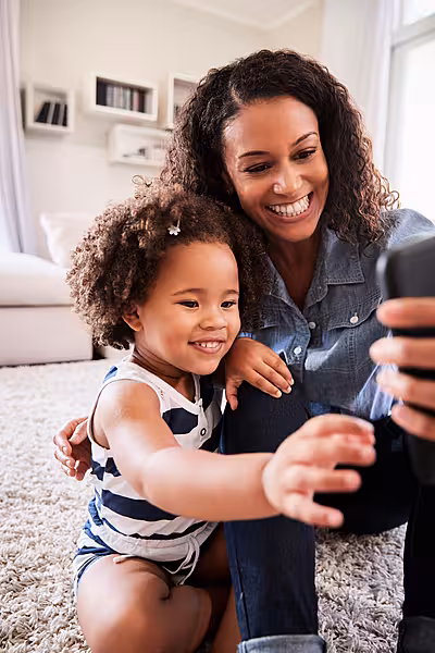 mother taking selfie with daughter