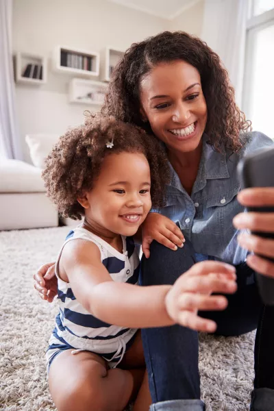 mother taking selfie with daughter