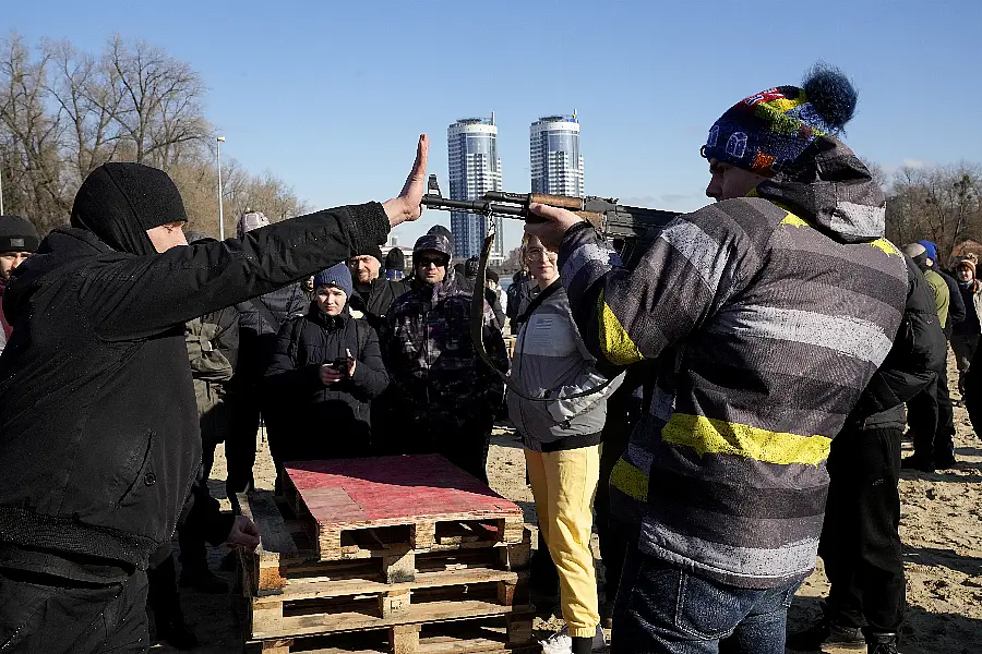 An instructor demonstrates how to use a Kalashnikov assault rifle in Kyiv 