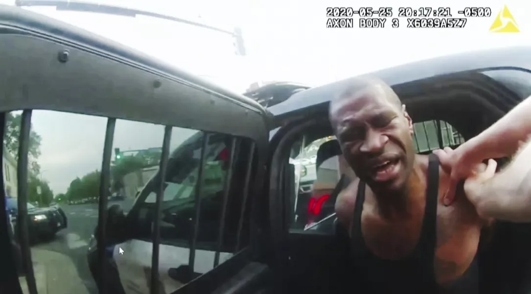 A screen grab from bodycam footage shows Minneapolis police officers attempting to place George Floyd in a police vehicle shortly before he was pinned to the ground