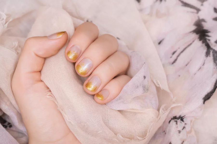 Nails with gold glitter polish