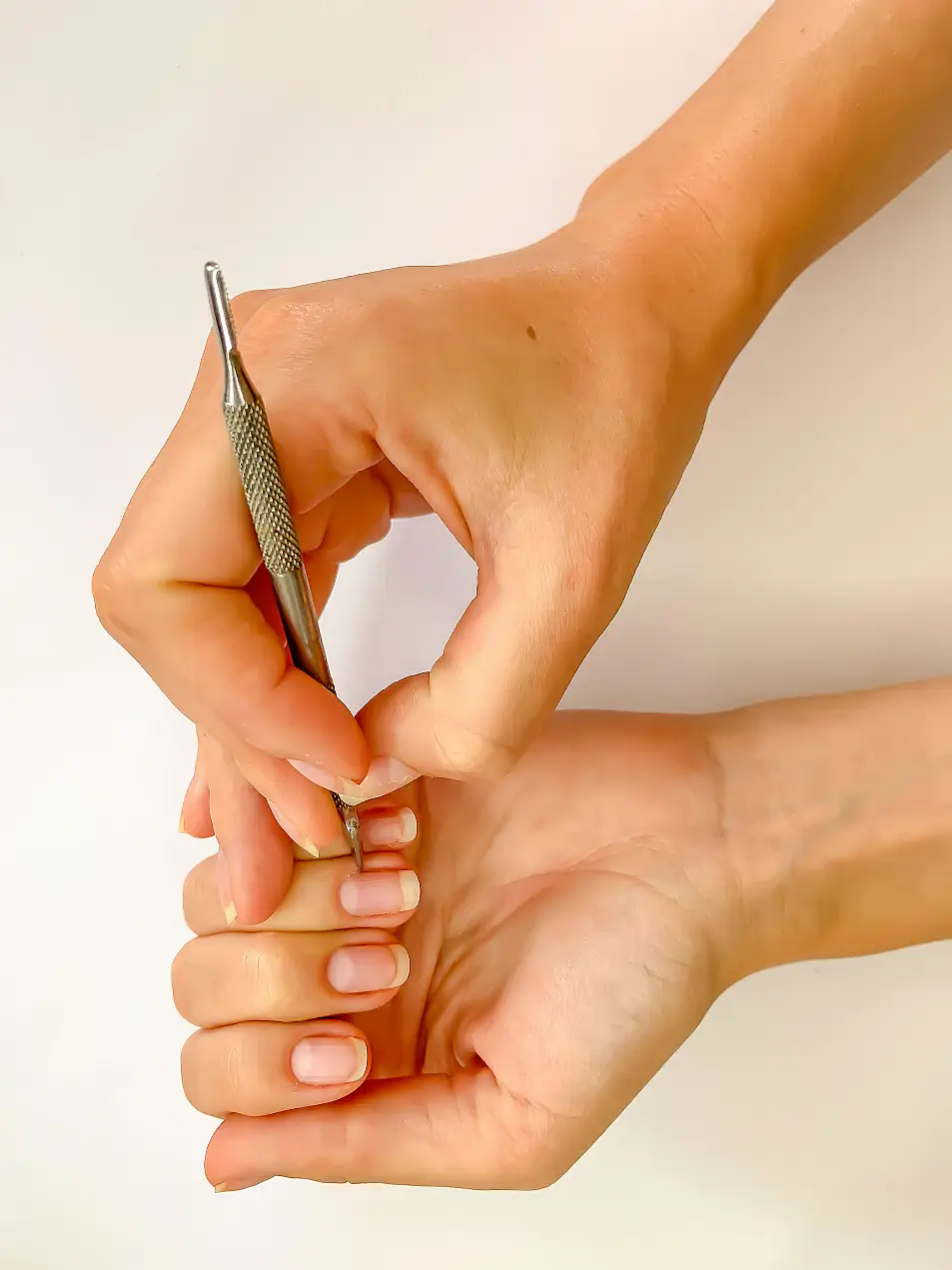 woman manicuring her nails