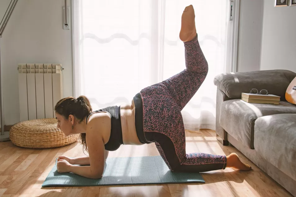 Woman doing yoga stretches at home