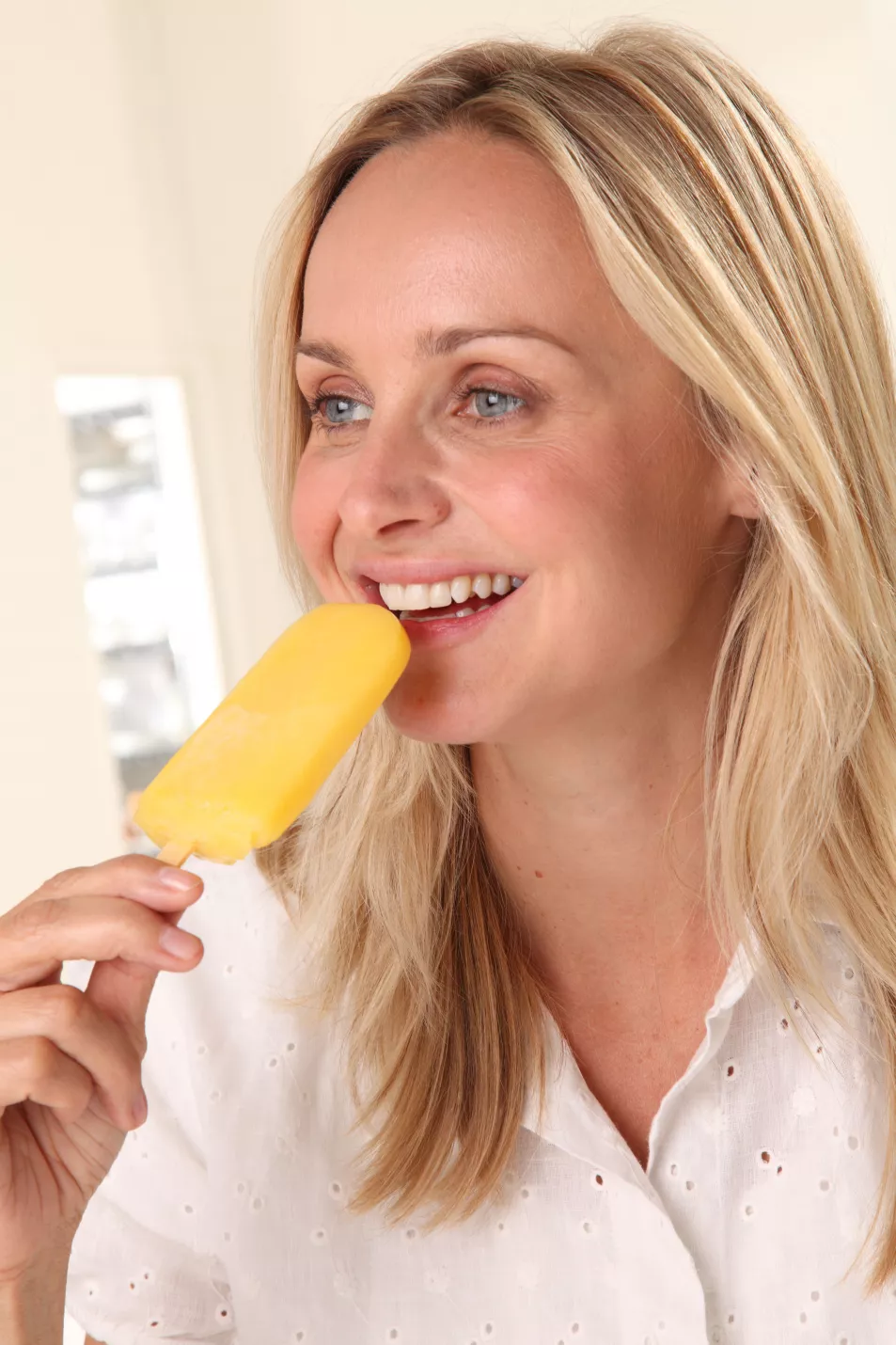 Woman eating an ice lolly