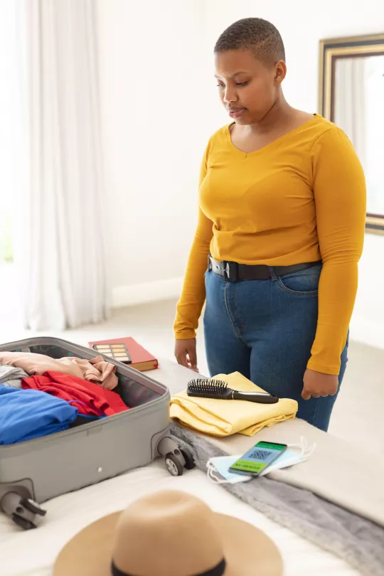 woman packing suitcase for holiday