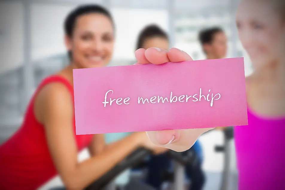 Woman holding card saying free membership