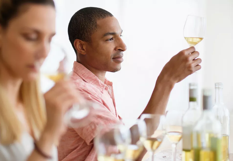 Man and woman tasting white wine