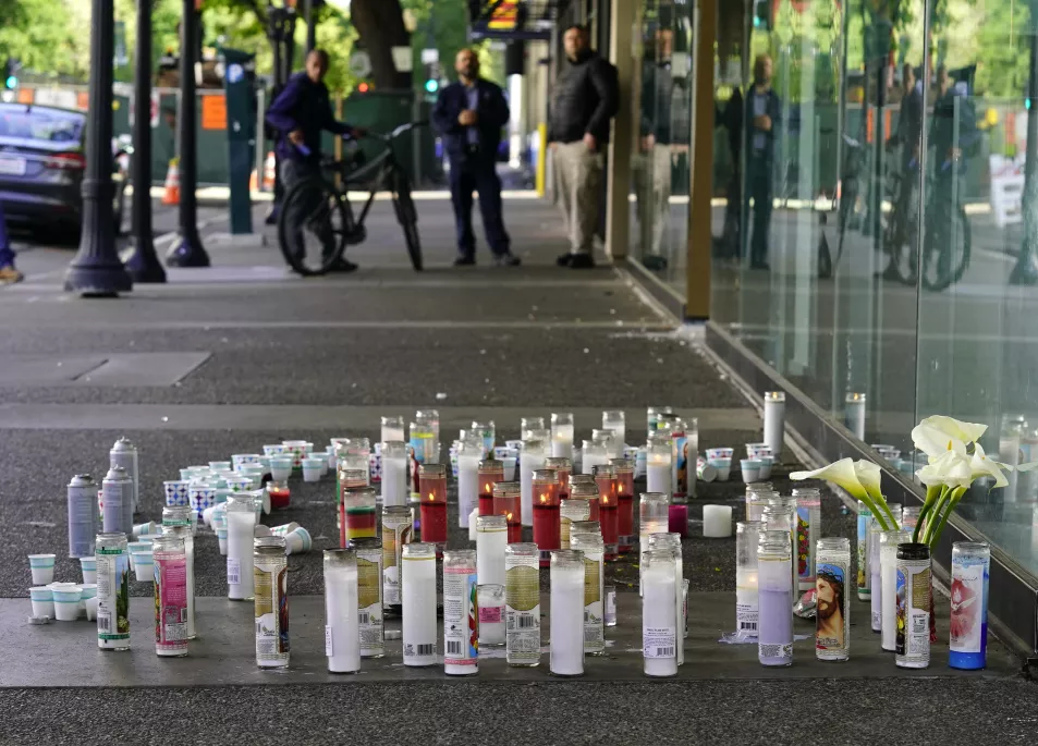 Candles and flowers make up a memorial, Tuesday, April 5,2022, at a memorial for those killed and injured in a mass shooting on April 3, 2022, in Sacramento, Calif. 