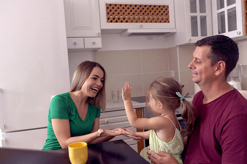 Little girl playing with parents