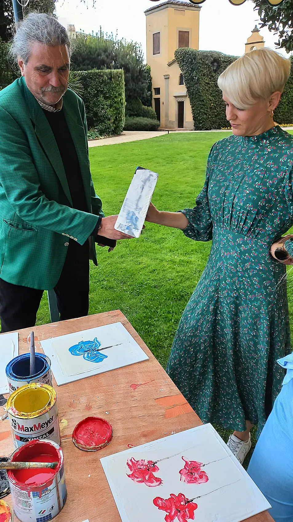 Roberto Guanieri (left) teaching Katie Wright to paint a floral fresco