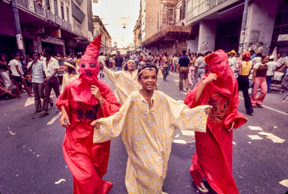 Costumed children run down the street during the 1975 Carnival 