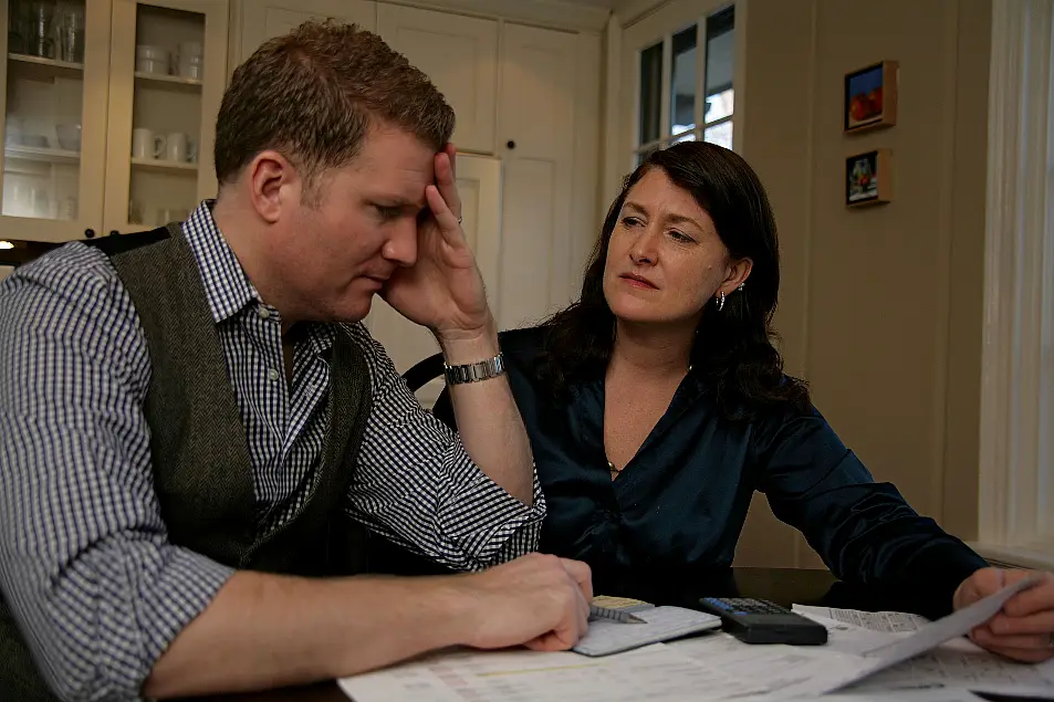 A husband and wife going over personal finance at the dining table