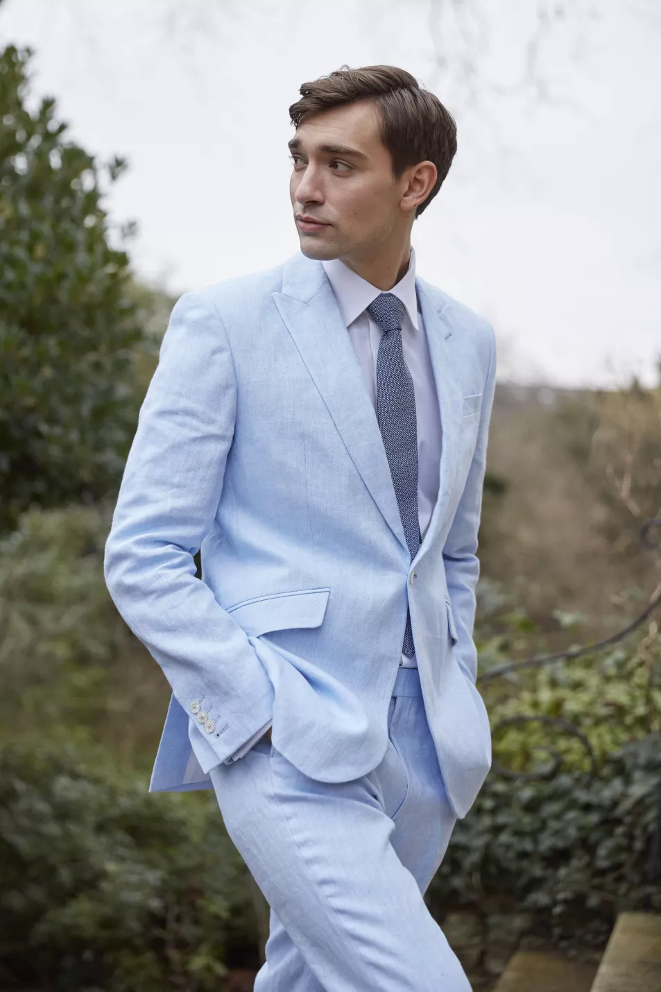 Man in pale blue linen suit