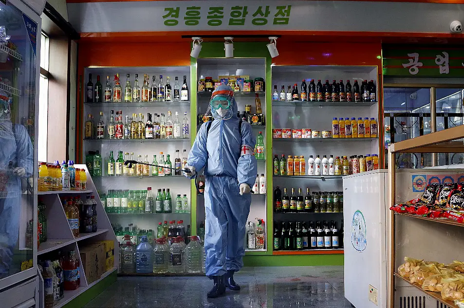 An employee of the Kyonghung Foodstuff General Store disinfects the showroom in Pyongyang, North Korea, Wednesday, Nov. 10, 2021