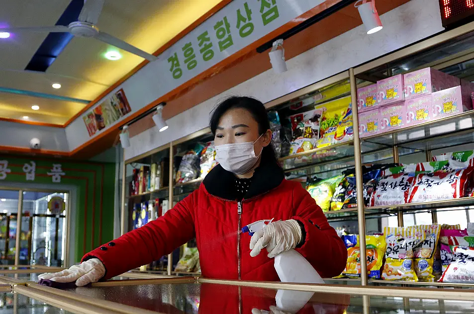 An employee of the Kyonghung Foodstuff General Store disinfects the showroom countertops in Pyongyang, North Korea, Wednesday, Nov. 10, 2021