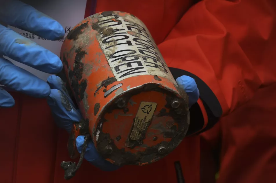 An orange-coloured 'black box' recorder recovered from the crash site 