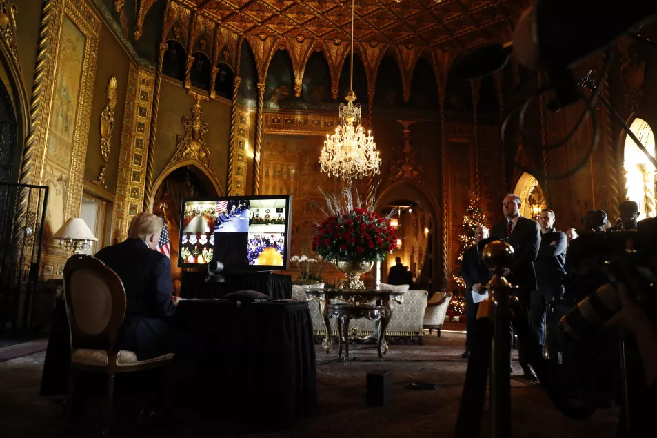 Then-President Donald Trump listens during a Christmas Eve video teleconference with members of the military at his Mar-a-Lago estate in Palm Beach, Florida, in 2019