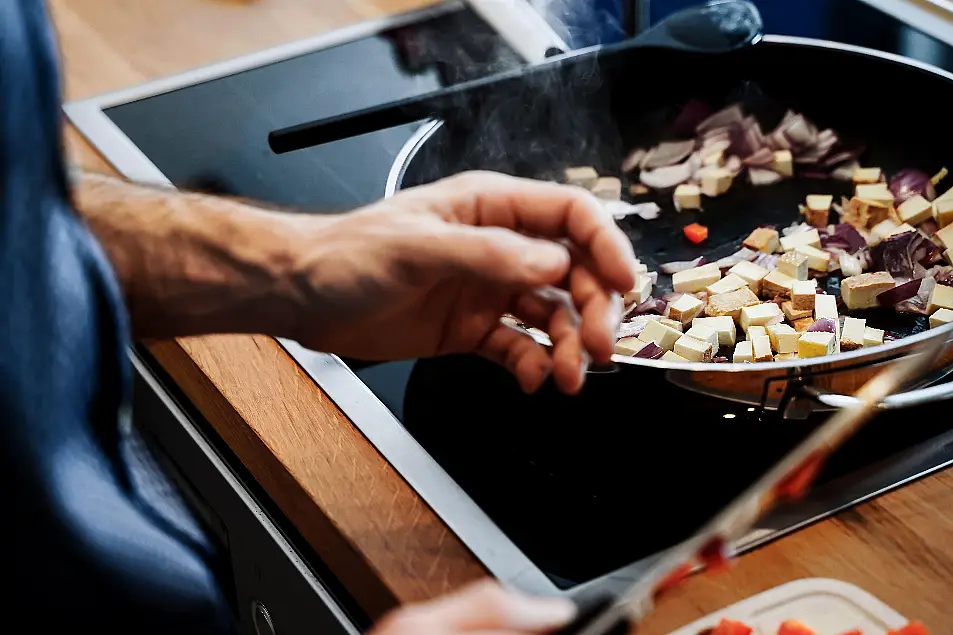 man cooking tofu