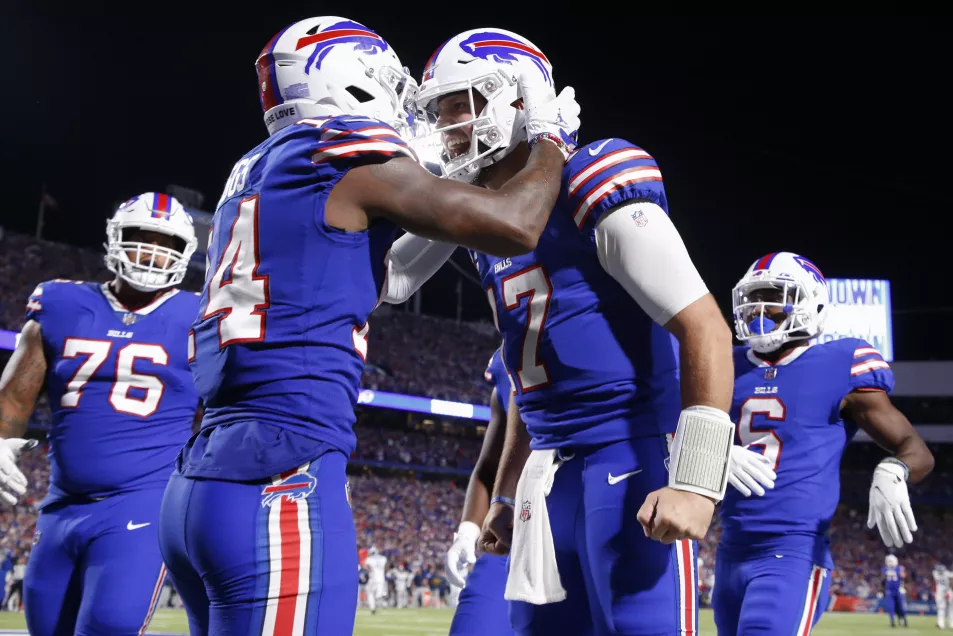 Buffalo Bills' Stefon Diggs, second from left, celebrates with quarterback Josh Allen, second from right, after they connected for a touchdown during the second half of an NFL football game against the Tennessee Titans 