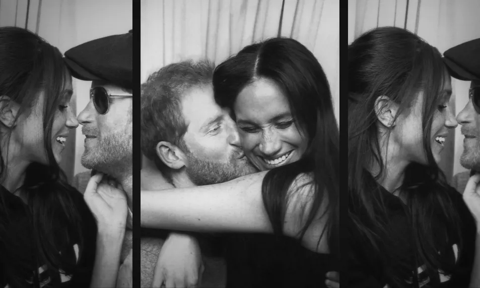 The couple cuddling in a photo booth 