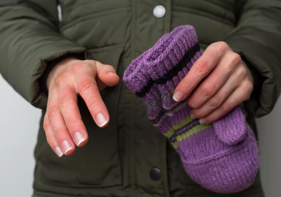 Frozen woman's hands in winter