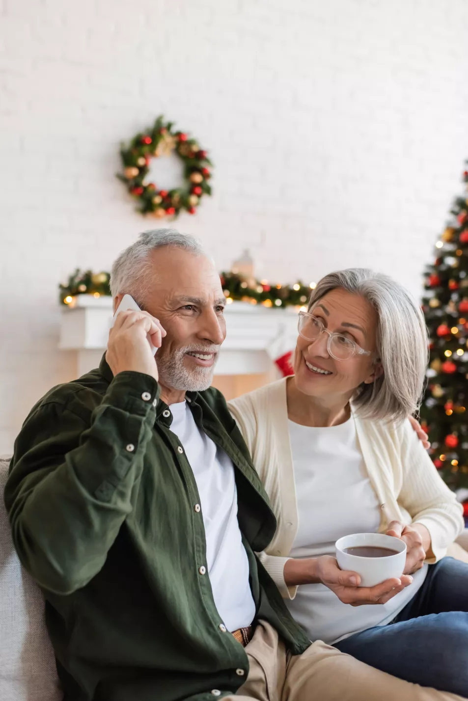 couple talking on phone at Christmas