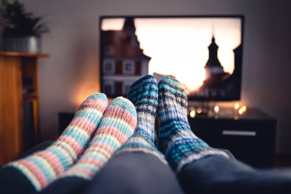couple wearing warm socks watching TV