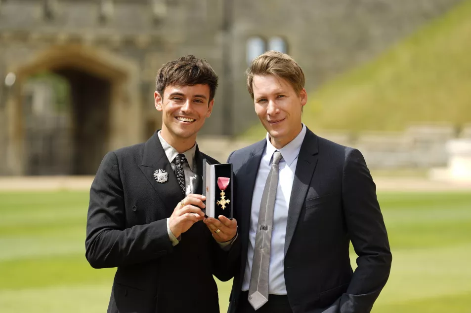 Tom Daley after receiving his OBE in 2022 with his husband Dustin Lance Black (Alamy/PA)