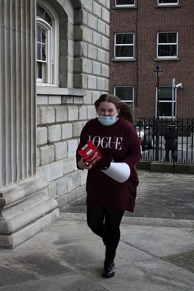 Girl walking with Easter egg in her hand and a mask on 