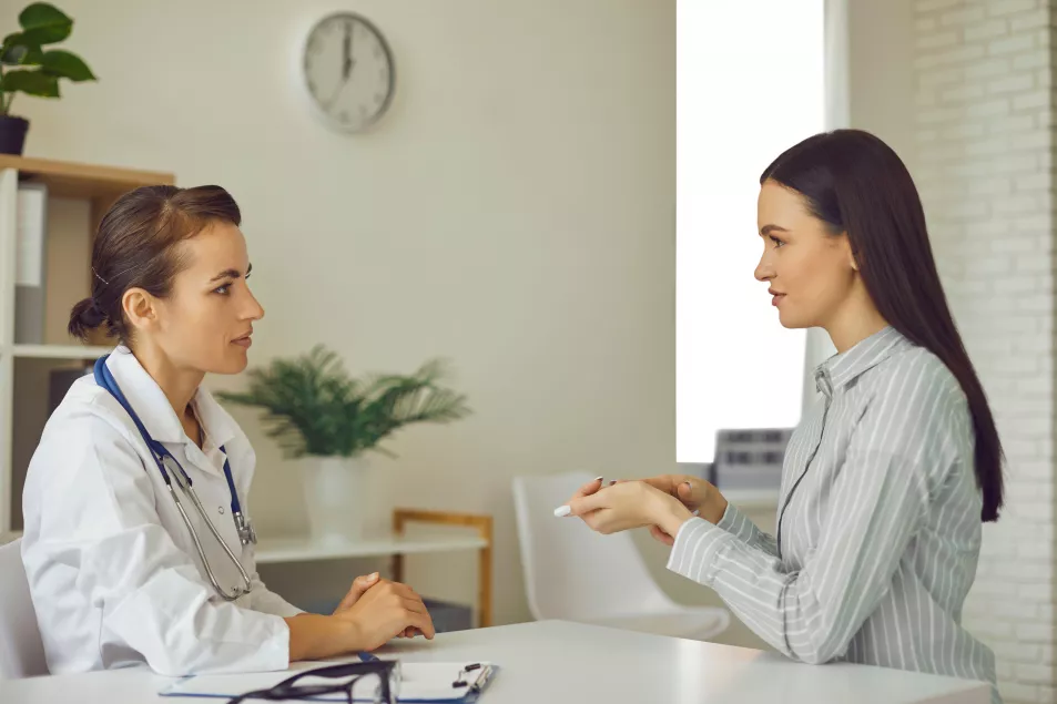 A woman talking with their GP