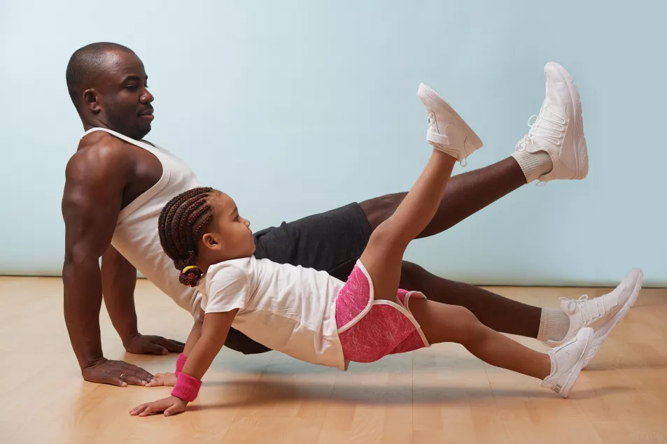 A father and child working out together