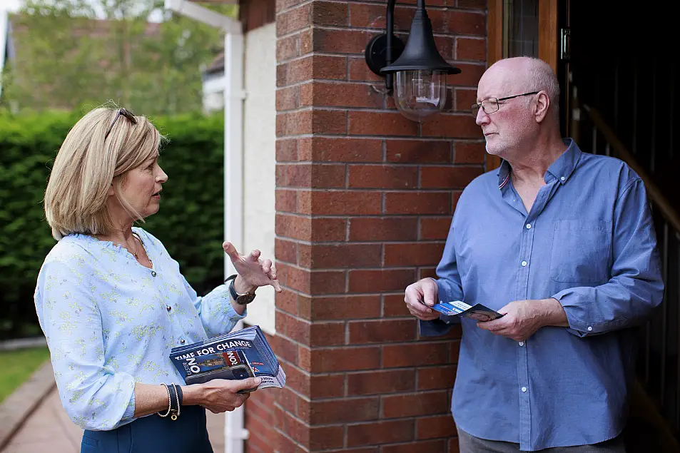 Diana Armstrong speaking to householder Michael McConville