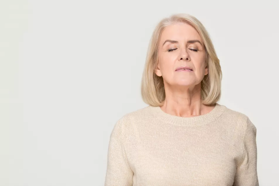 Calm middle-aged woman breathing slowly