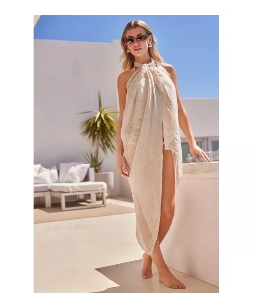 Woman wears sarong as dress it is nude with pinstripes