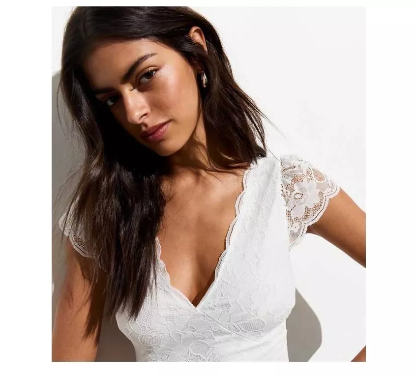 Woman wears white lace top 