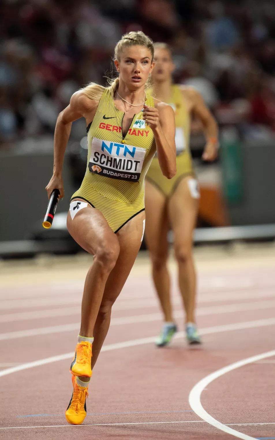 Alica Schmidt runs with batton on track at Budapest