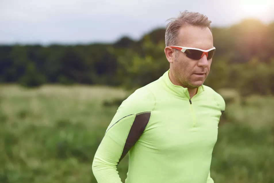 Man running outdoors in sunglasses