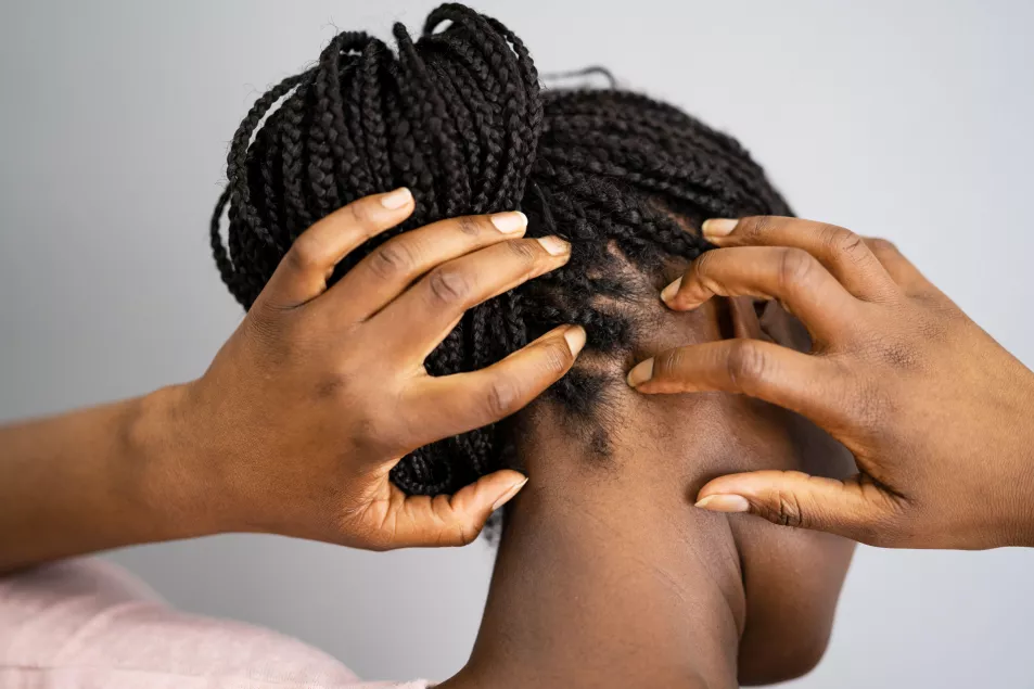 Person touching their scalp