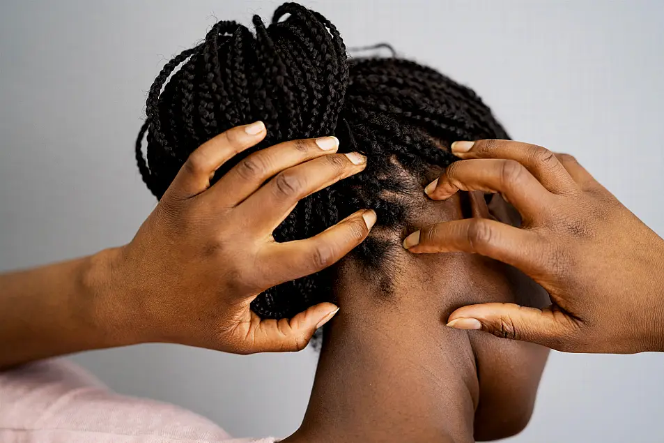 Person touching their scalp