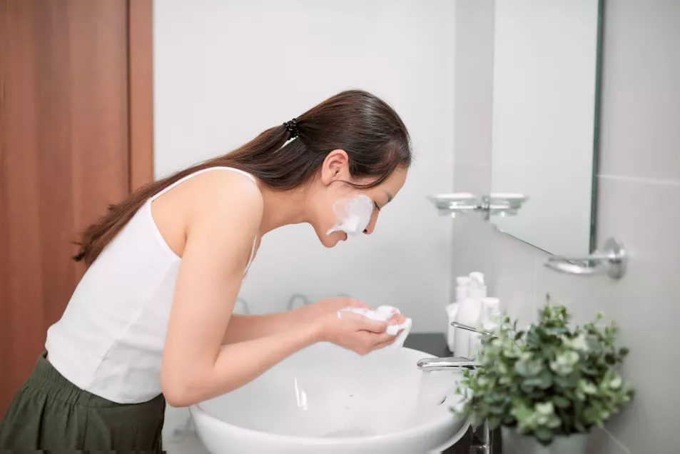 Woman cleansing her face
