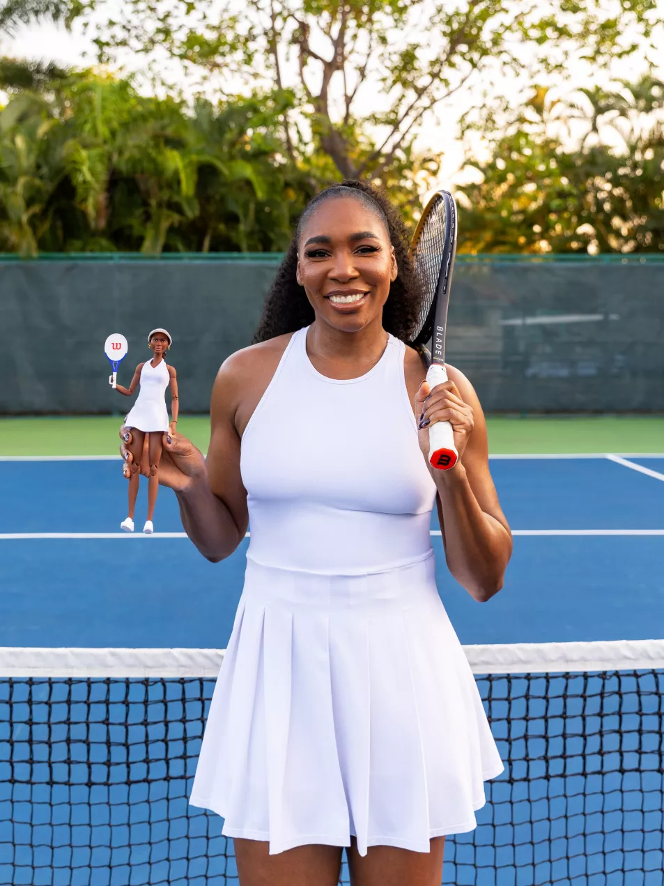 US tennis player Venus Williams posing with a Barbie doll created in her likeness 