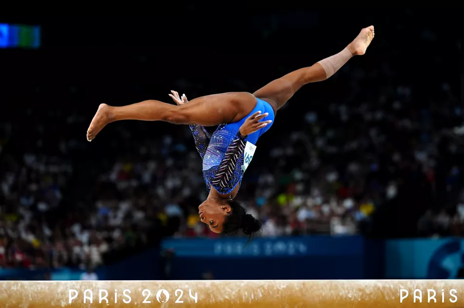 Simone Biles performs on the balance beam during the Women's All-Around Final at the Bercy Arena