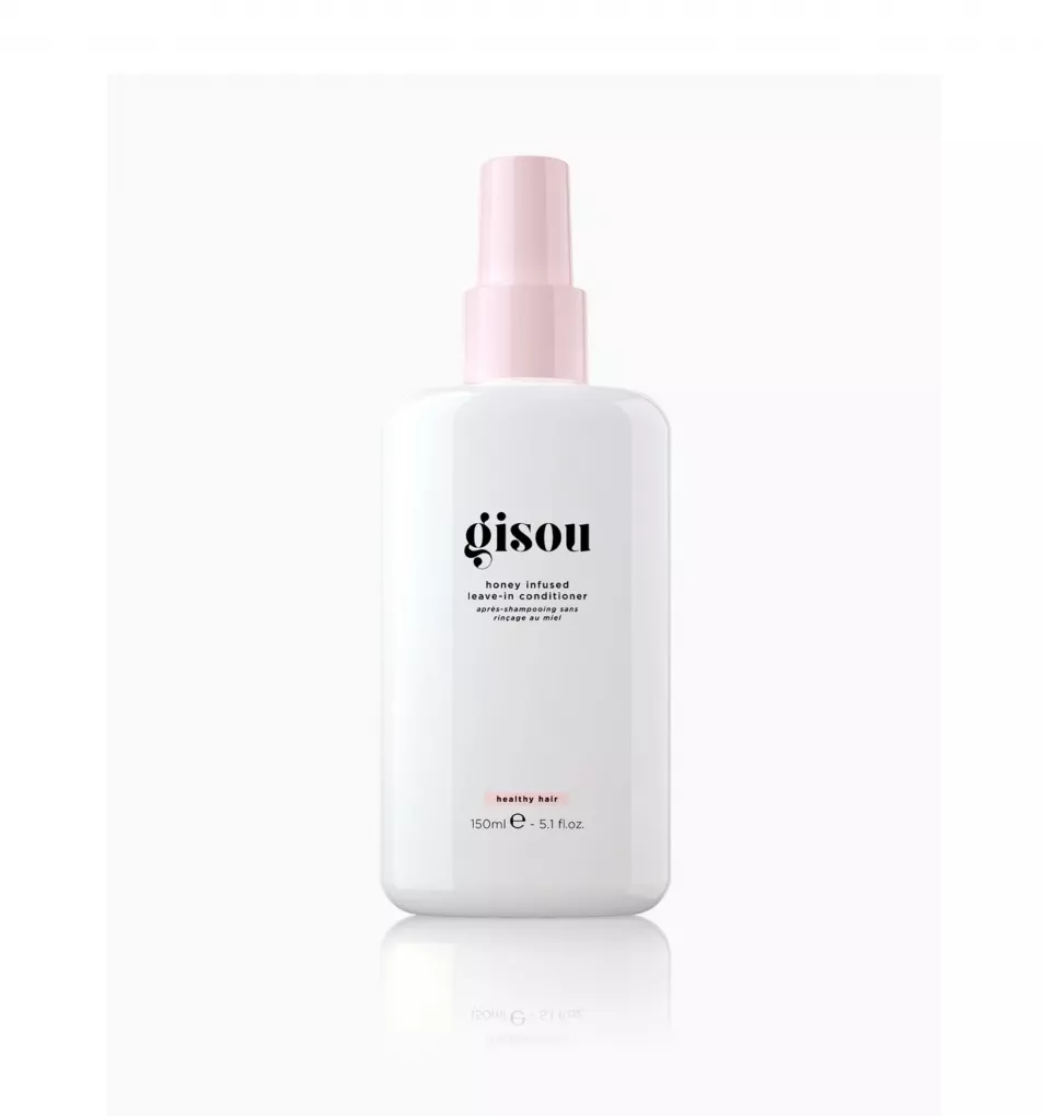 White plastic spray bottle with pink lid of leave in conditioner