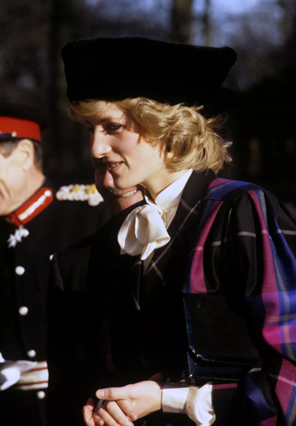 Princess Diana smiles in pink and blue tartan blazer and cream pussybow blouse during a visit to Shrewsbury