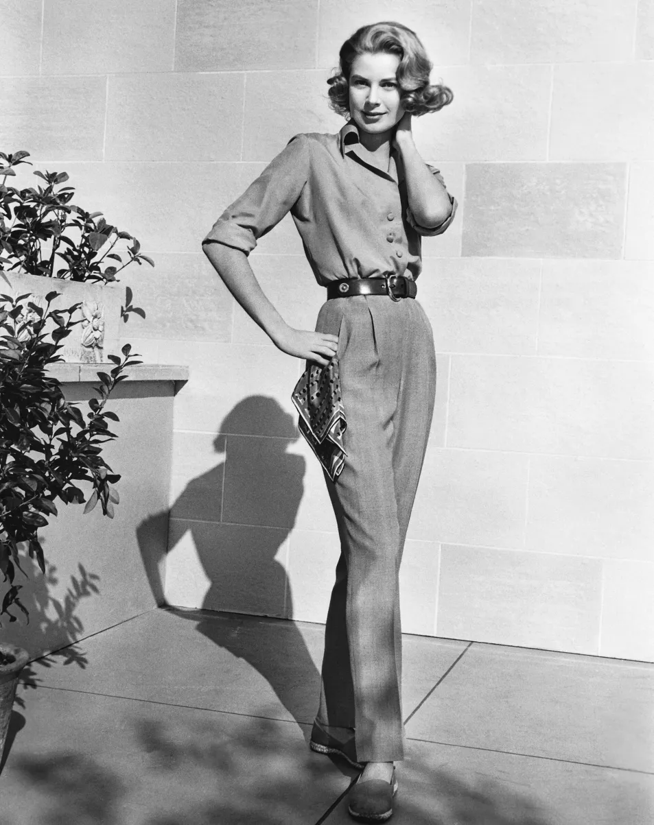 Grace Kelly poses in shirt, leather belt and tailored trousers