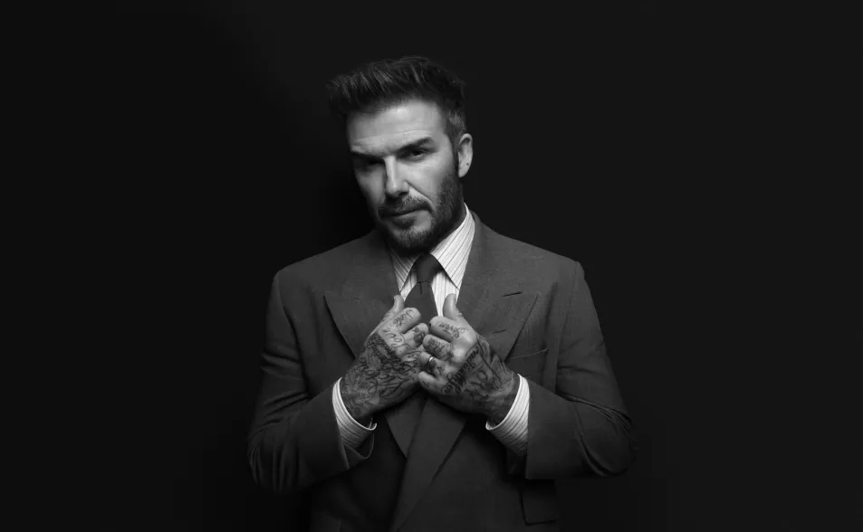 Beckham straightens tie in black and white shot wearing hugo boss suit