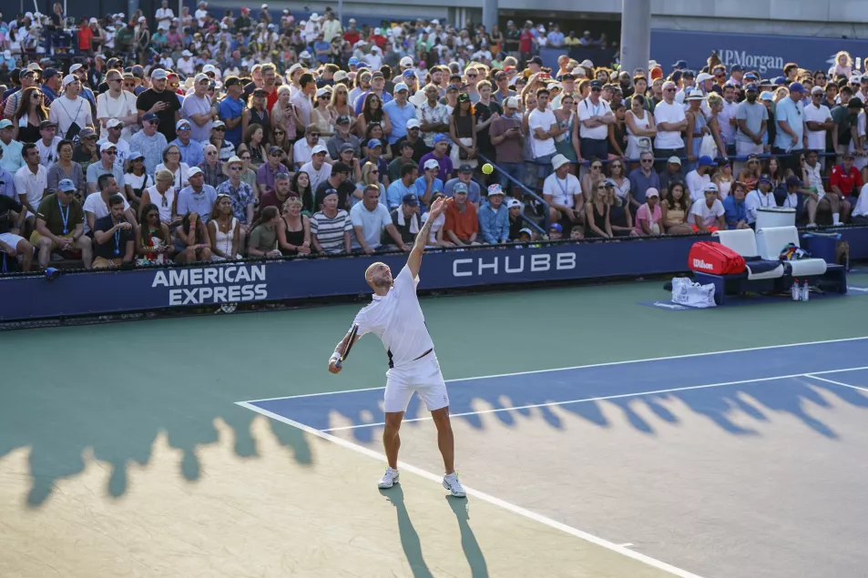 Dan Evans hits a serve 