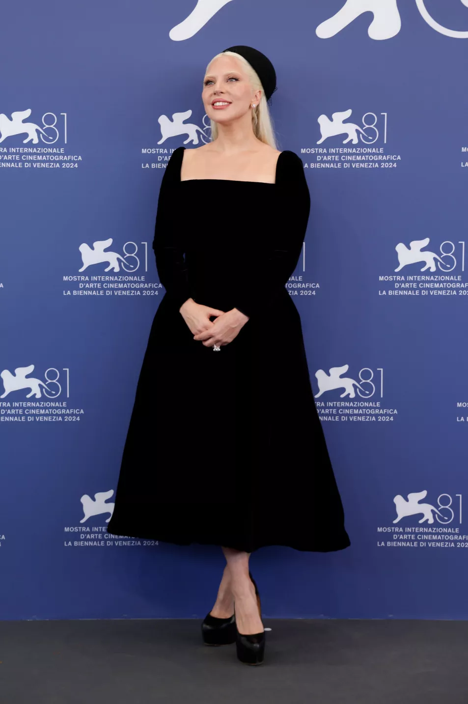 Gaga poses in black midi velvet dress in Venice