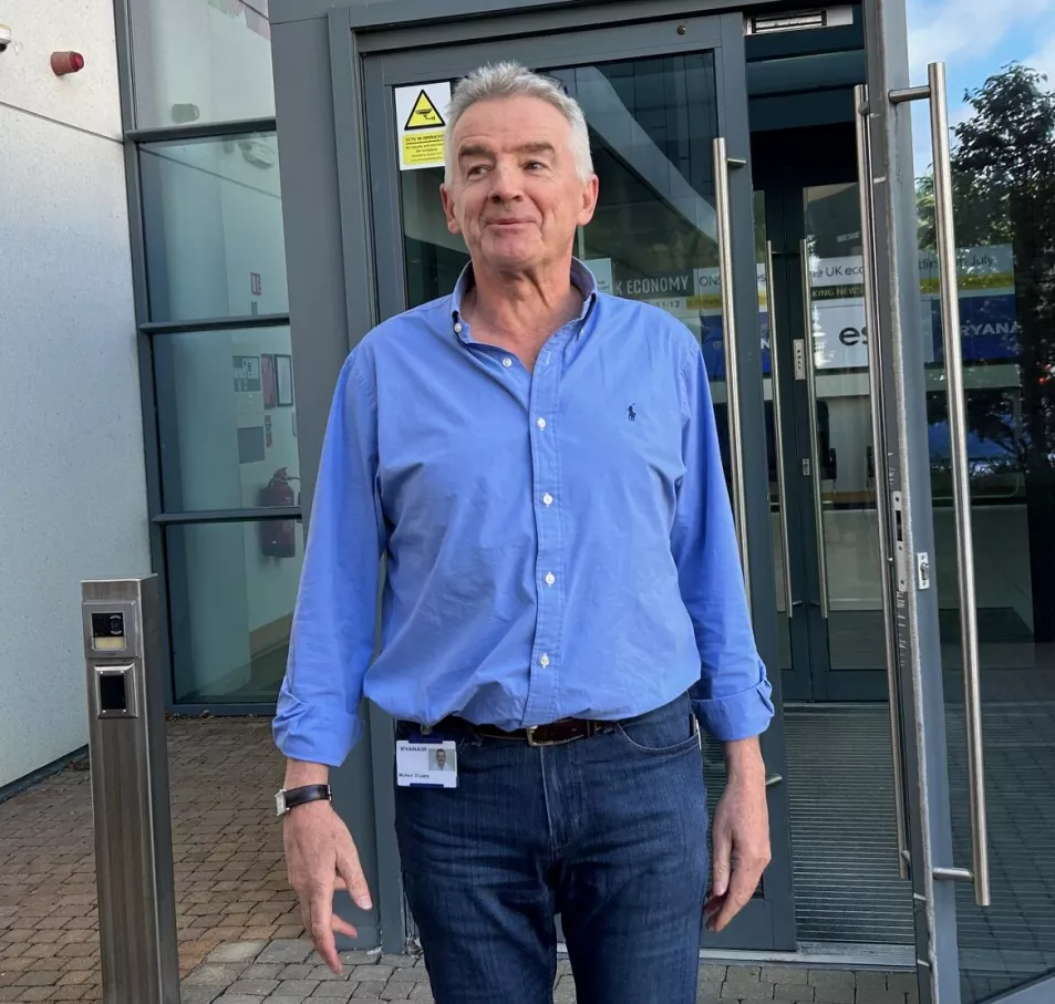 Ryanair boss Michael O'Leary leaving a building dressed in jeans and a shirt